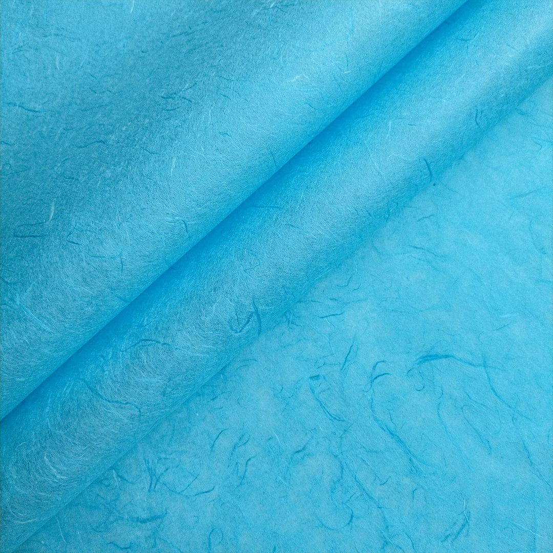 Close-up of Atoll Blue Unryu handmade paper by Kozo Studio, highlighting textured mulberry fibers for a natural artisan look.