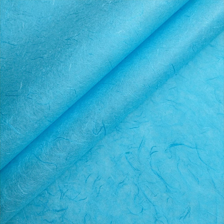 Close-up of Atoll Blue Unryu handmade paper by Kozo Studio, highlighting textured mulberry fibers for a natural artisan look.