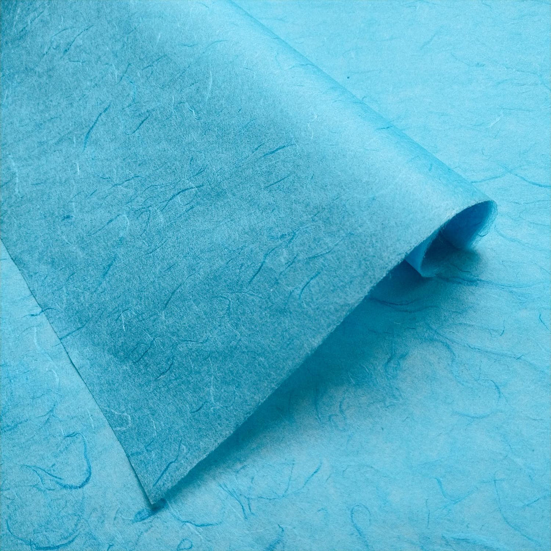 Detailed image of folded Unryu mulberry paper from Kozo Studio, featuring visible fibers and the unique handmade paper texture.