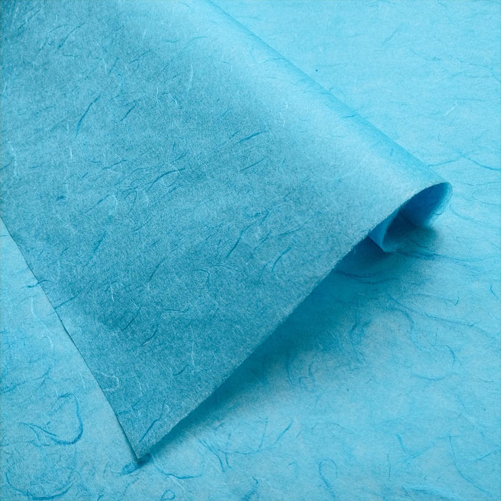 Detailed image of folded Unryu mulberry paper from Kozo Studio, featuring visible fibers and the unique handmade paper texture.