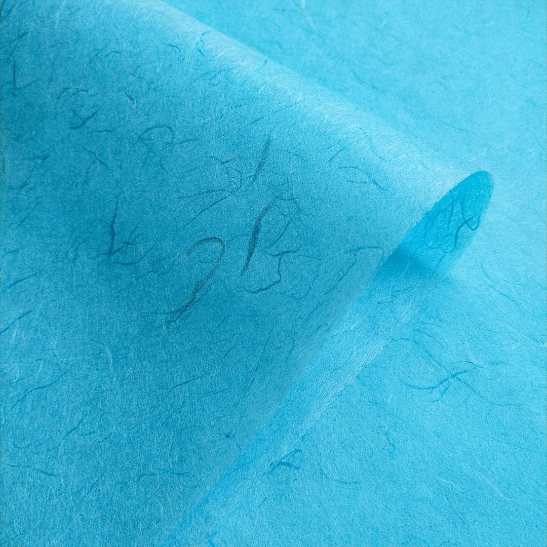 Picture showing folded Unryu Kozo Studio handmade paper, with pronounced mulberry fibers for an organic and textured appearance.