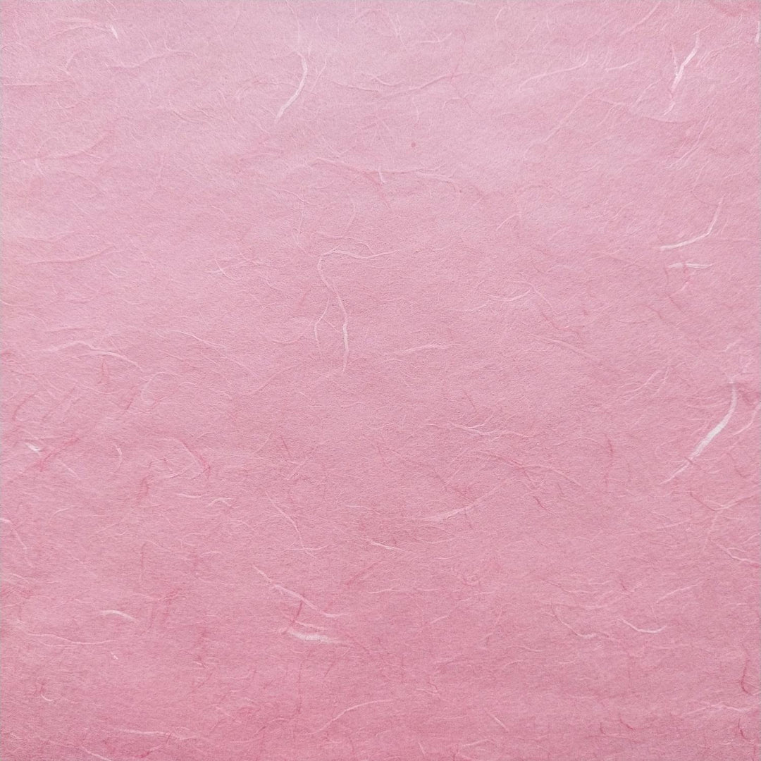 Detailed image of Kozo Studio Classic Pink handmade paper with visible mulberry fibers and natural shadows.
