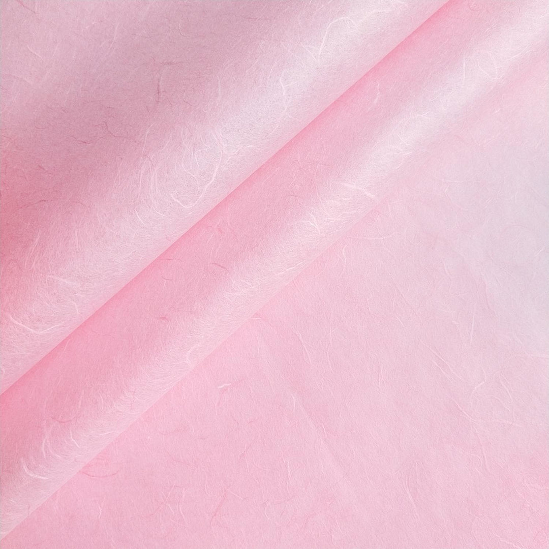 Close-up of Kozo Studio handmade paper in Classic Pink showing fibrous texture and natural mulberry paper details.