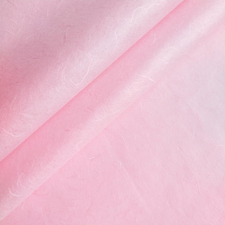 Close-up of Kozo Studio handmade paper in Classic Pink showing fibrous texture and natural mulberry paper details.