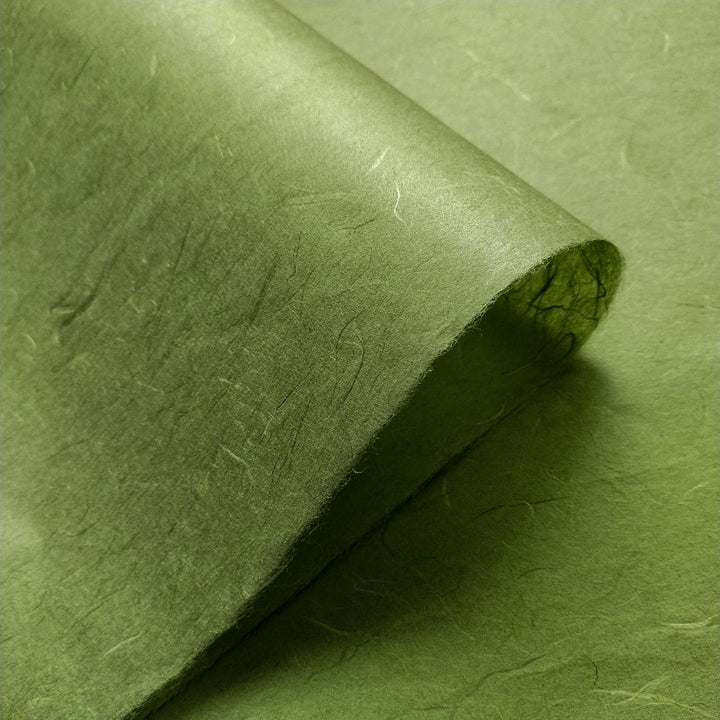 Detailed image of fern green handmade paper from Kozo Studio, highlighting the fibrous texture of Unryu mulberry paper.