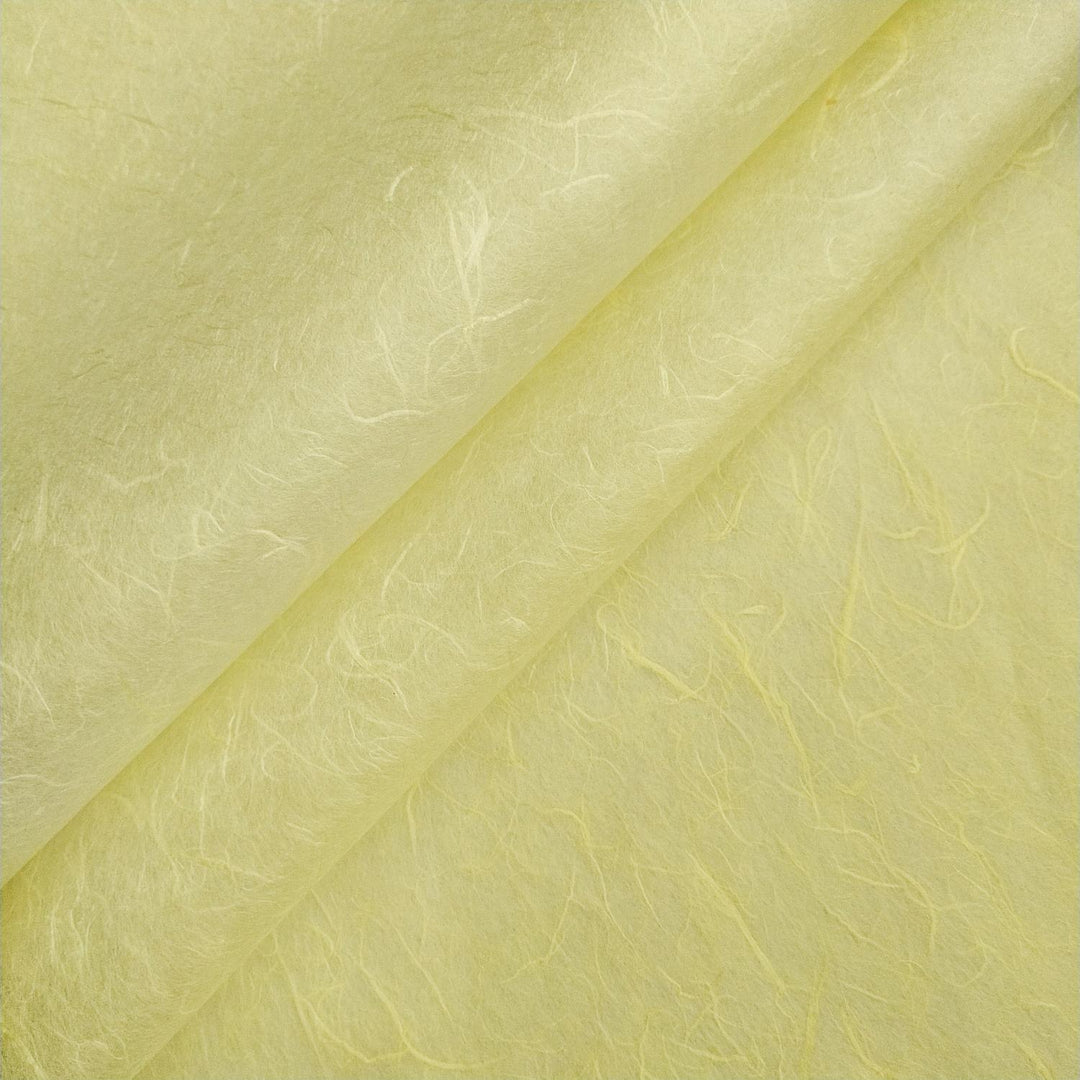 Close-up of lemon yellow Unryu mulberry paper from Kozo Studio, showcasing delicate handmade paper fibers and organic textures.