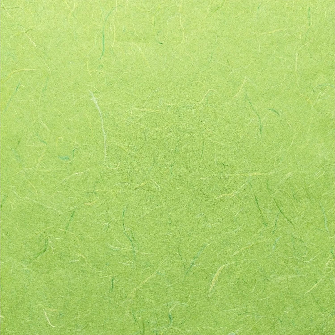 Textured mulberry paper in lime green by Kozo Studio showcasing crumpled handmade paper surface and natural fibers.