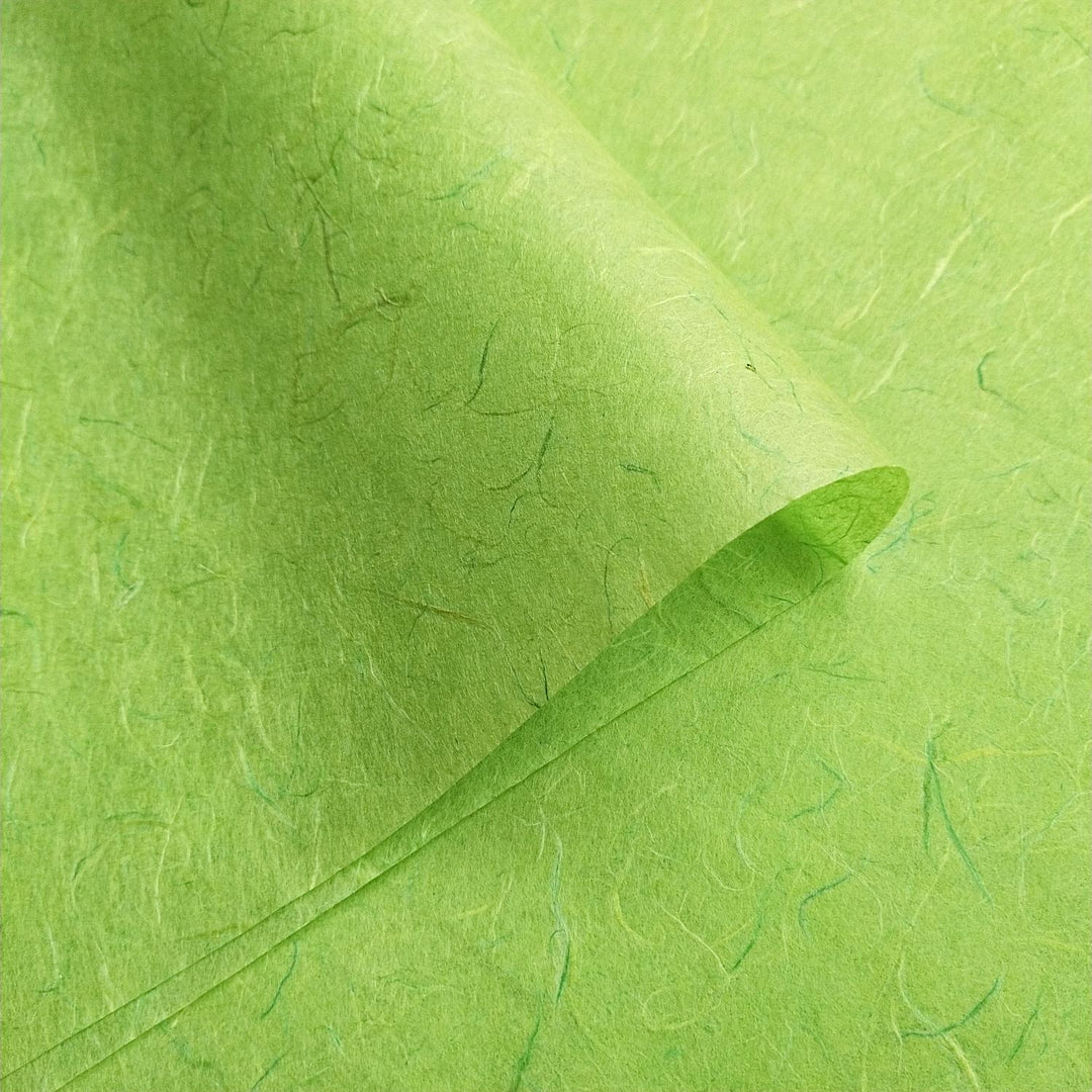 Handmade lime green mulberry paper by Kozo Studio featuring a fibrous look and layered textures.