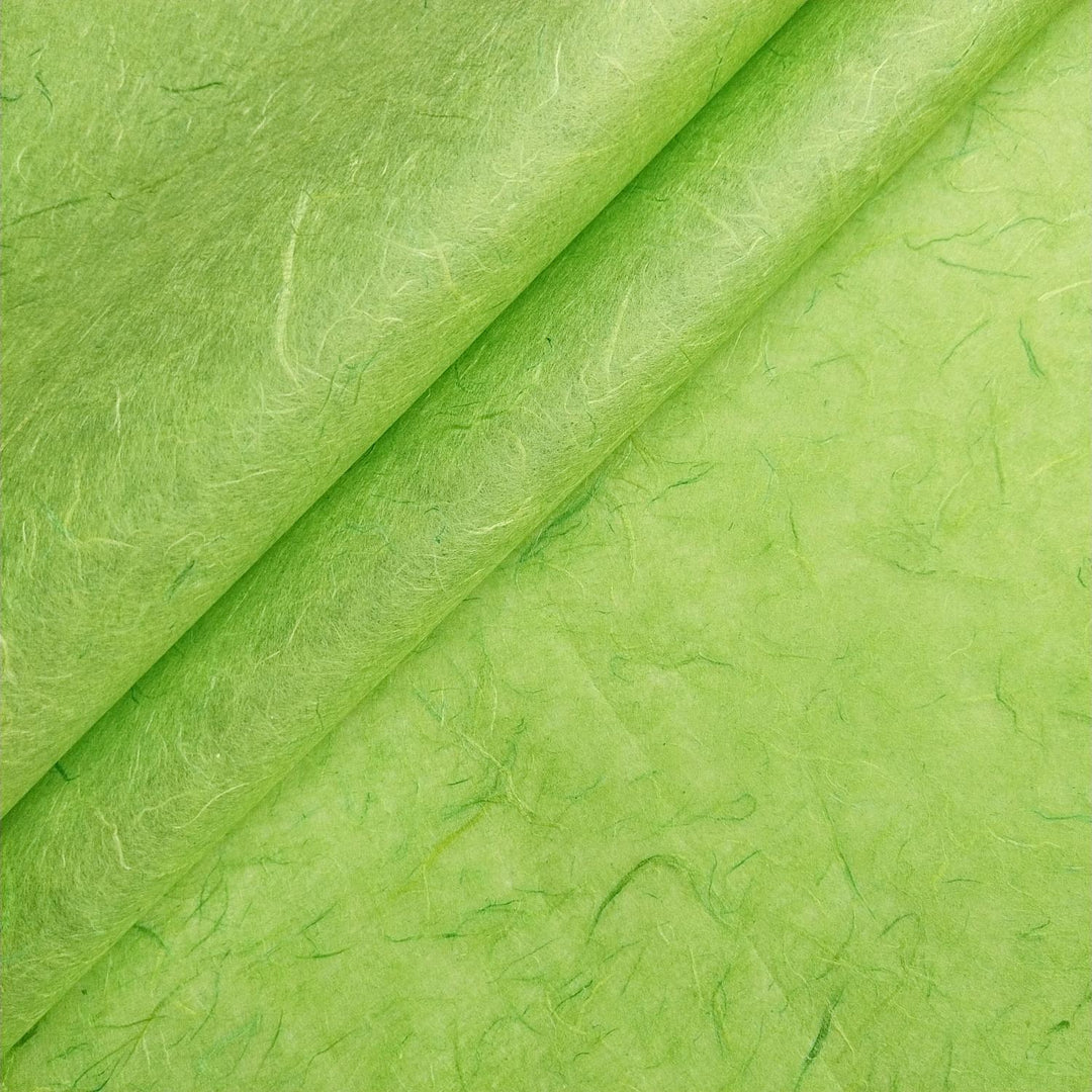 Lime green Unryu handmade paper from Kozo Studio with fibrous texture and visible mulberry threads.