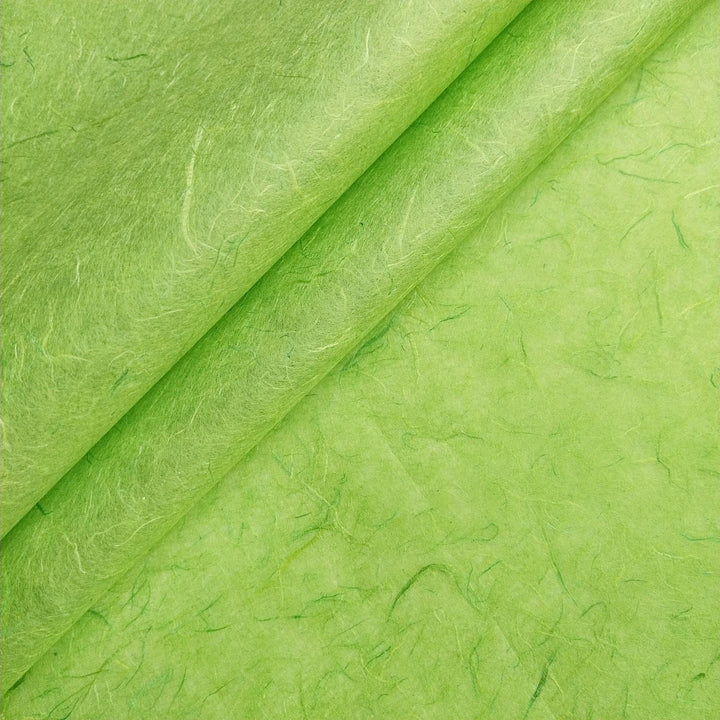 Lime green Unryu handmade paper from Kozo Studio with fibrous texture and visible mulberry threads.