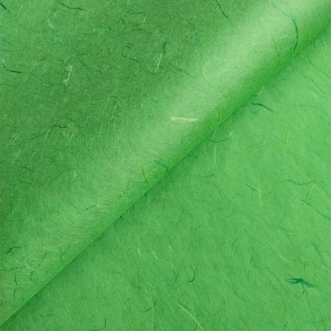 Textured surface of green Unryu mulberry paper by Kozo Studio, emphasizing handmade paper fibers and organic design.