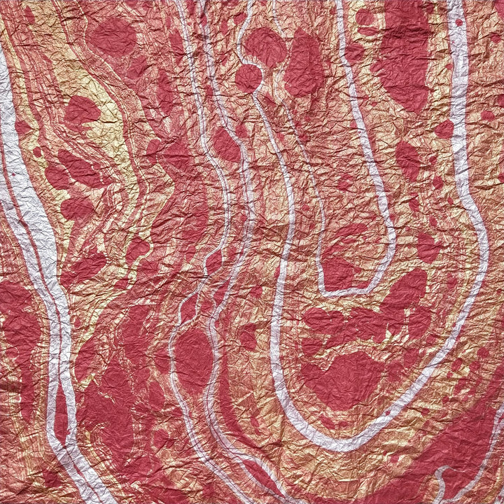 Artisan-crafted mulberry paper with a red marbled design from Kozo Studio, highlighting the rich texture and elegance of handmade paper.