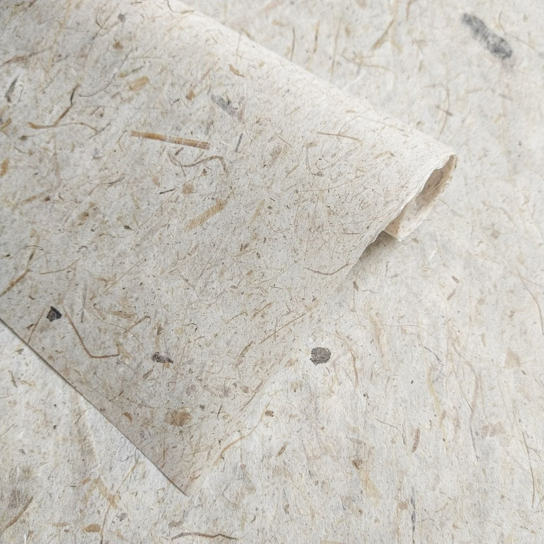 Kozo Studio's Banana Kozo paper with visible banana trunk fibers and mulberry texture, offering a warm, organic feel for handmade paper art.