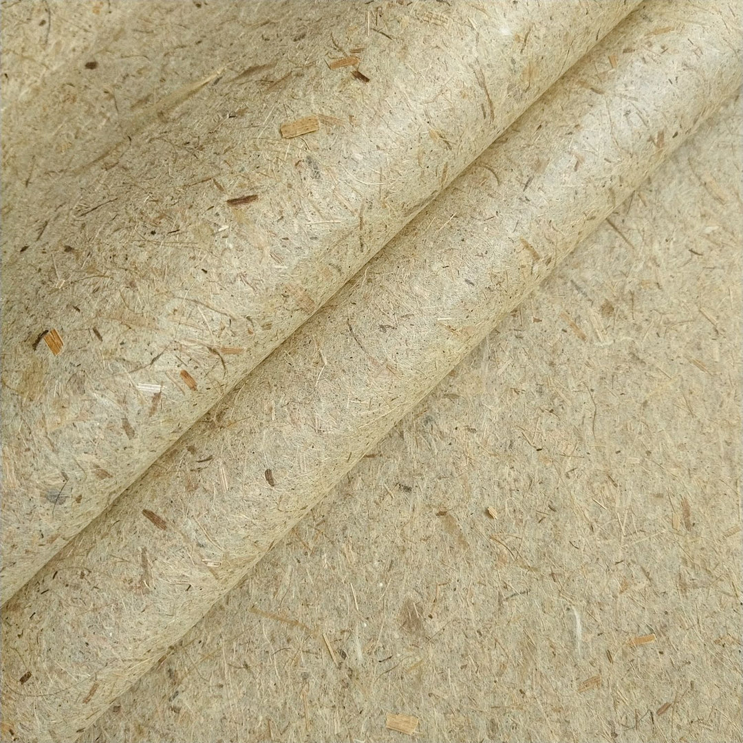 Close-up image of Kozo Studio handmade paper crafted from banana fiber and mulberry paper pulp, highlighting its fibrous beige texture with natural specks.