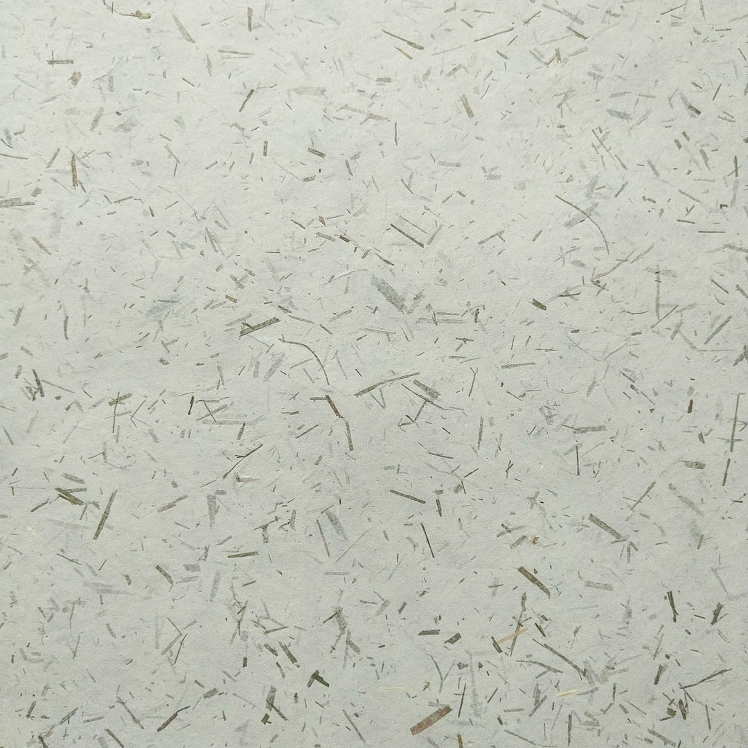 Detailed image of Kozo Studio's Bamboo Confetti Kozo, a decorative handmade mulberry paper made from paper mulberry pulp and organic bamboo accents.