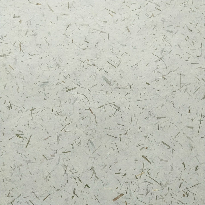 Detailed image of Kozo Studio's Bamboo Confetti Kozo, a decorative handmade mulberry paper made from paper mulberry pulp and organic bamboo accents.