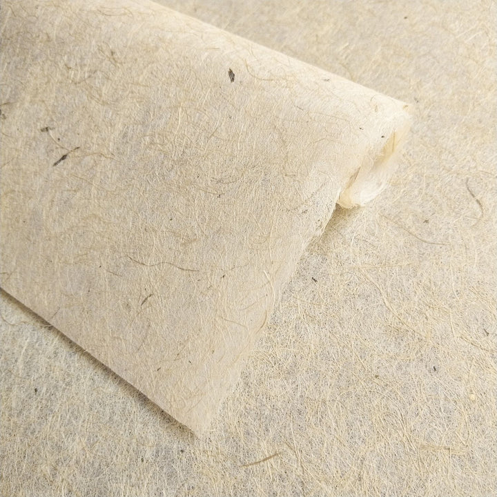 Textured handmade paper from Kozo Studio crafted with jute and mulberry fiber, highlighting the natural finish and eco-conscious appeal for art lovers.