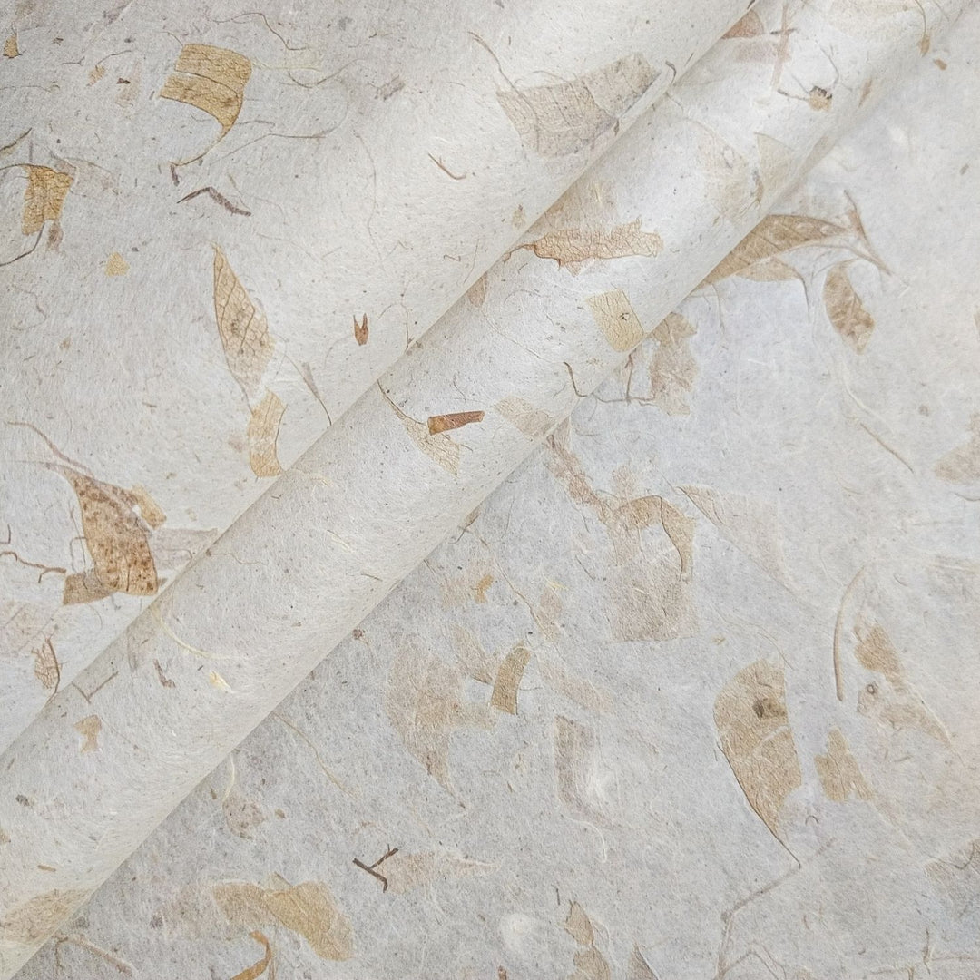 Close-up of Mango Leaf Kozo paper by Kozo Studio, showcasing the textured surface of handmade mulberry paper with embedded mango leaves and fibrous patterns.