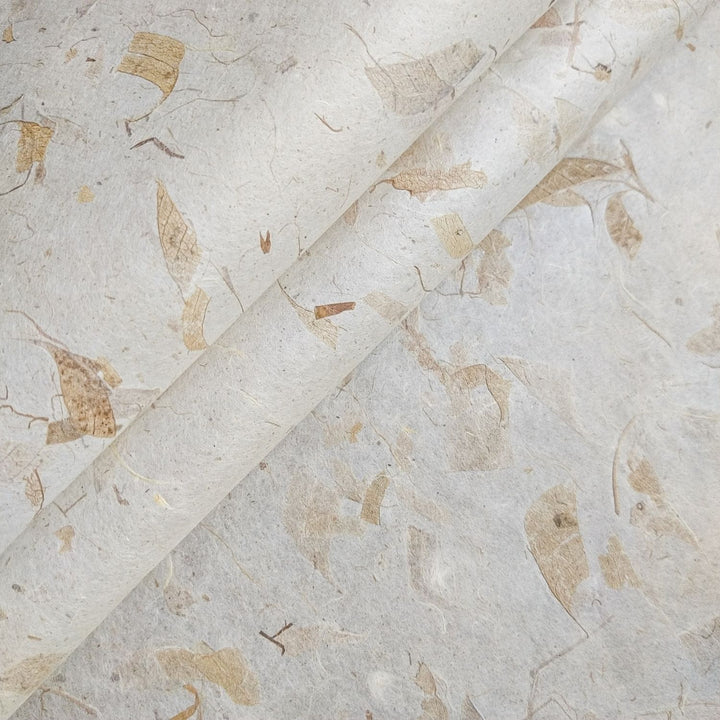 Close-up of Mango Leaf Kozo paper by Kozo Studio, showcasing the textured surface of handmade mulberry paper with embedded mango leaves and fibrous patterns.