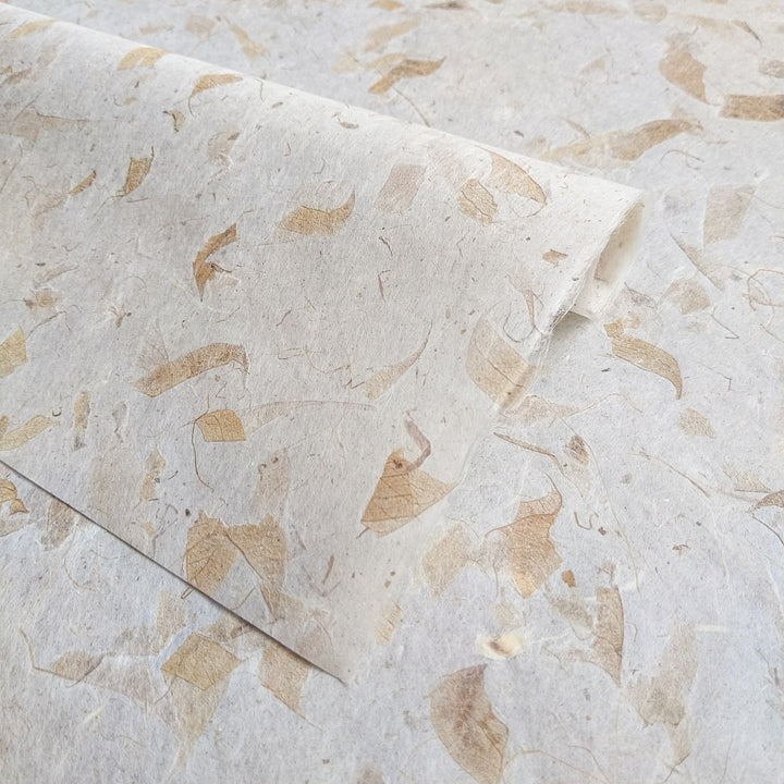 Artistic mango leaf paper by Kozo Studio made from mulberry bark, featuring overlapping layers and earthy fibers that reflect traditional handmade paper techniques.