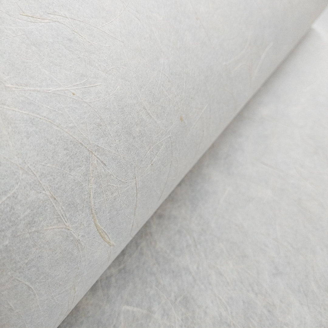 Kozo Studio's Mikado Kozo handmade paper close-up, featuring translucent mulberry paper with shimmering hemp strands for a subtle yet elegant effect.