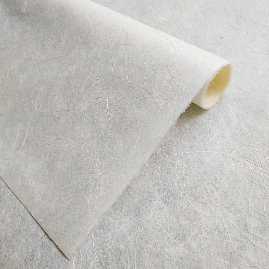 Textured surface of Mikado Kozo mulberry paper by Kozo Studio, showcasing its unique mix of kozo and hemp in a clean, minimalist handmade paper design.