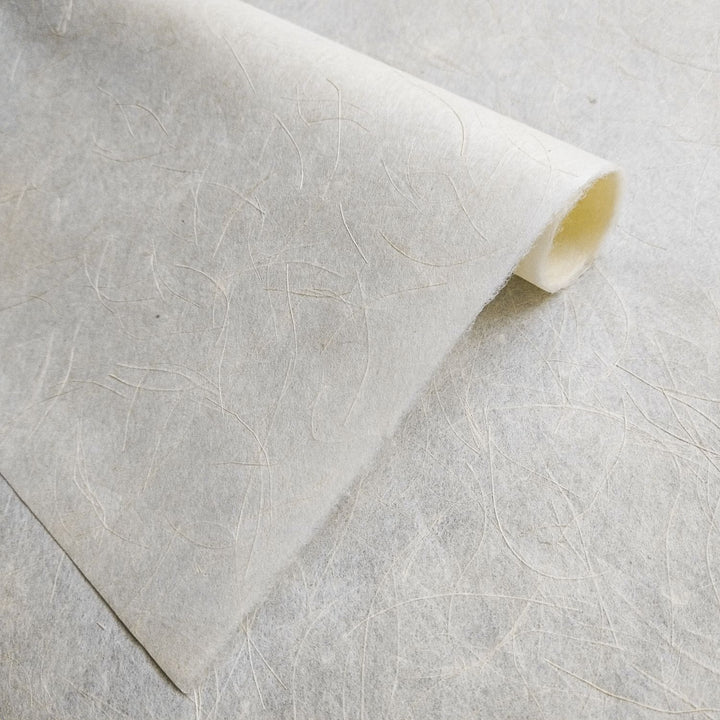 Textured surface of Mikado Kozo mulberry paper by Kozo Studio, showcasing its unique mix of kozo and hemp in a clean, minimalist handmade paper design.
