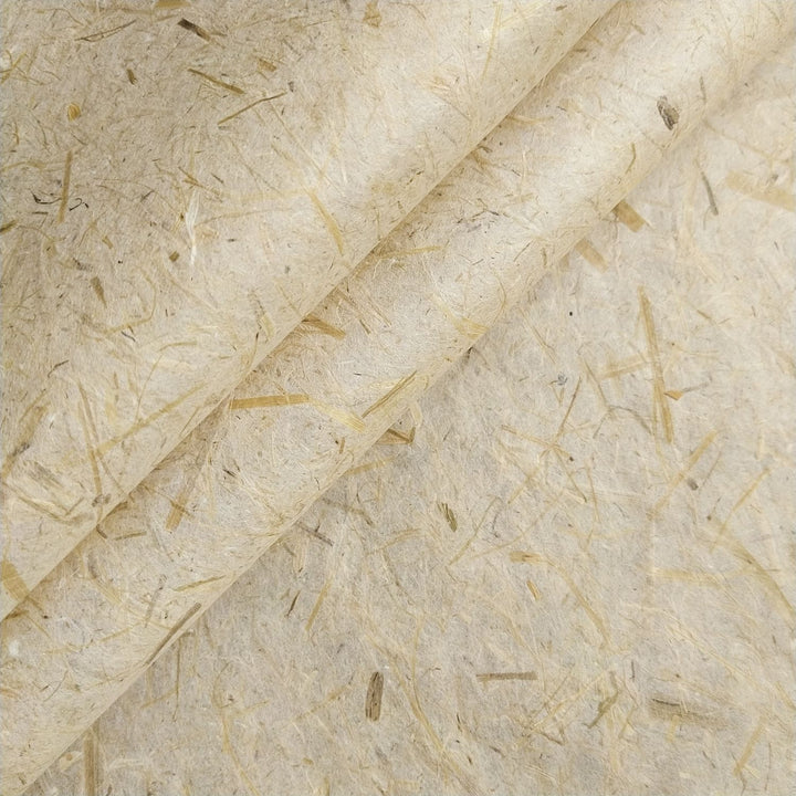 Close-up of handmade mulberry paper from Kozo Studio featuring rice straw inclusions, textured fibers, and a semi-translucent, organic surface.