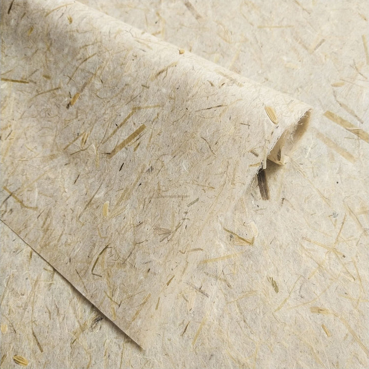 Kozo Studio handmade paper sheet made from mulberry pulp and grain by-products, with rice straw details giving it a raw, earthy aesthetic.
