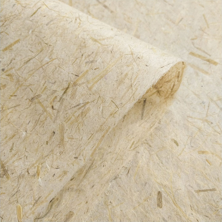 Textured mulberry paper from Kozo Studio, created using sustainable methods with rice straw accents and a semi-translucent finish perfect for creative uses.