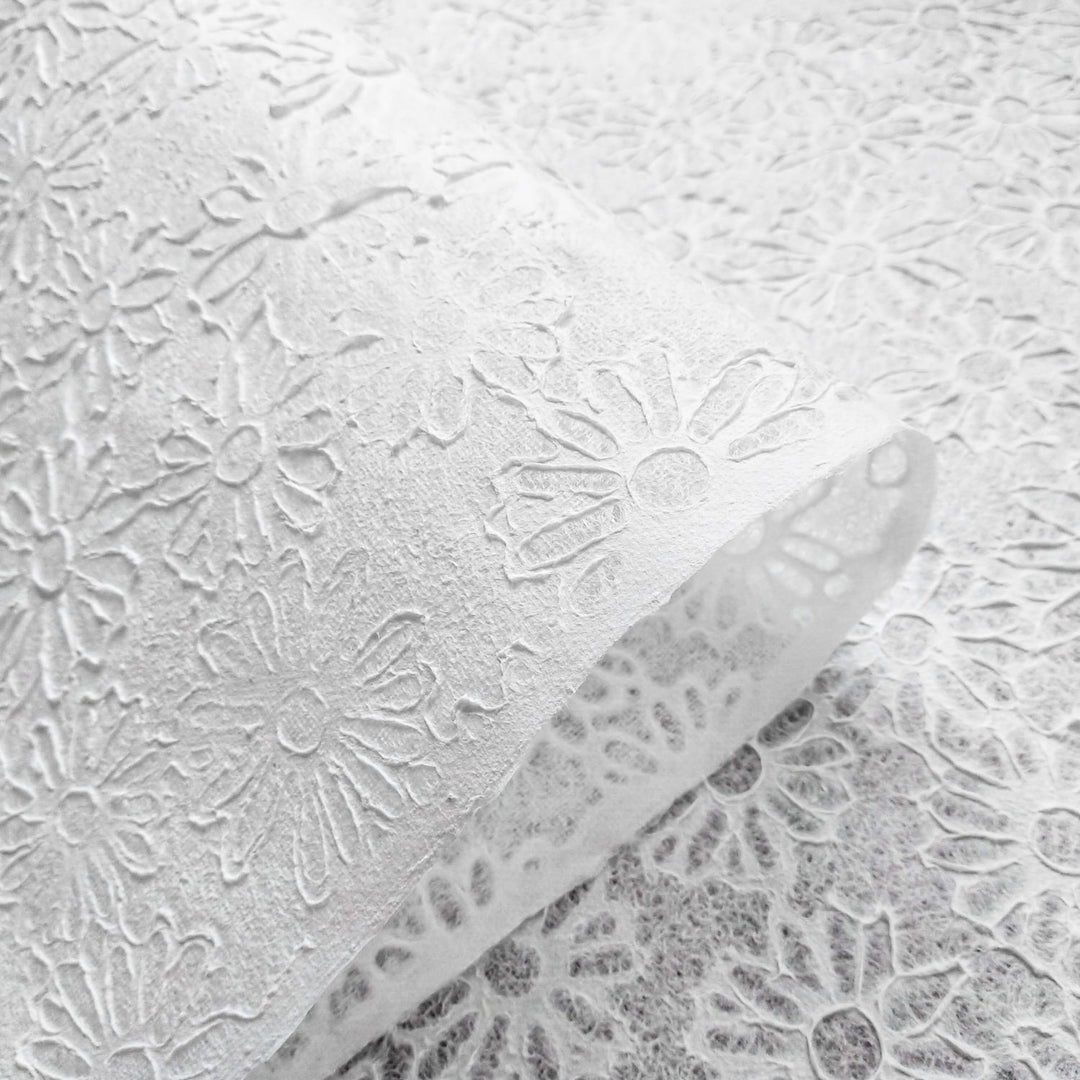 Kozo Studio handmade paper sheet with elegant floral embossing and natural fiber texture, made from mulberry paper using water-displacement artistry.