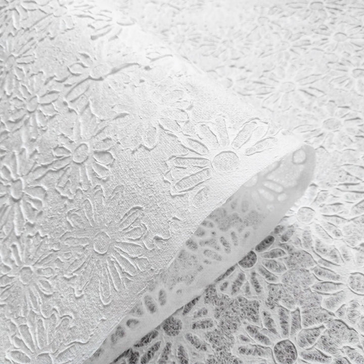 Kozo Studio handmade paper sheet with elegant floral embossing and natural fiber texture, made from mulberry paper using water-displacement artistry.