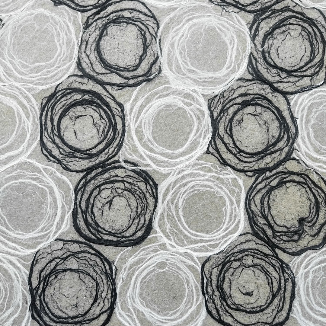 Kozo Studio handmade paper showcasing black and white circular rose motifs on lightweight mulberry paper, suited for design and DIY.