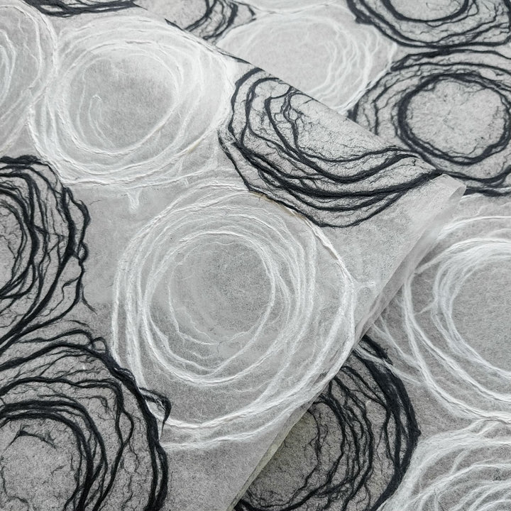 Translucent handmade mulberry paper with detailed rose-inspired patterns by Kozo Studio, perfect for lamps, windows, and fine art.