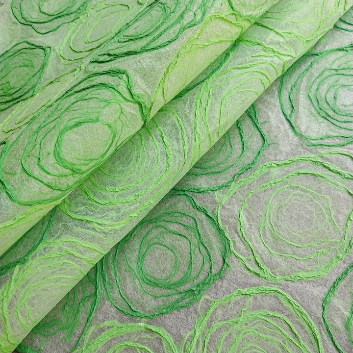 Elegant Kozo Studio handmade paper crafted with care, featuring green and light green rose-like pulp circles on thin mulberry paper for versatile art and design use.