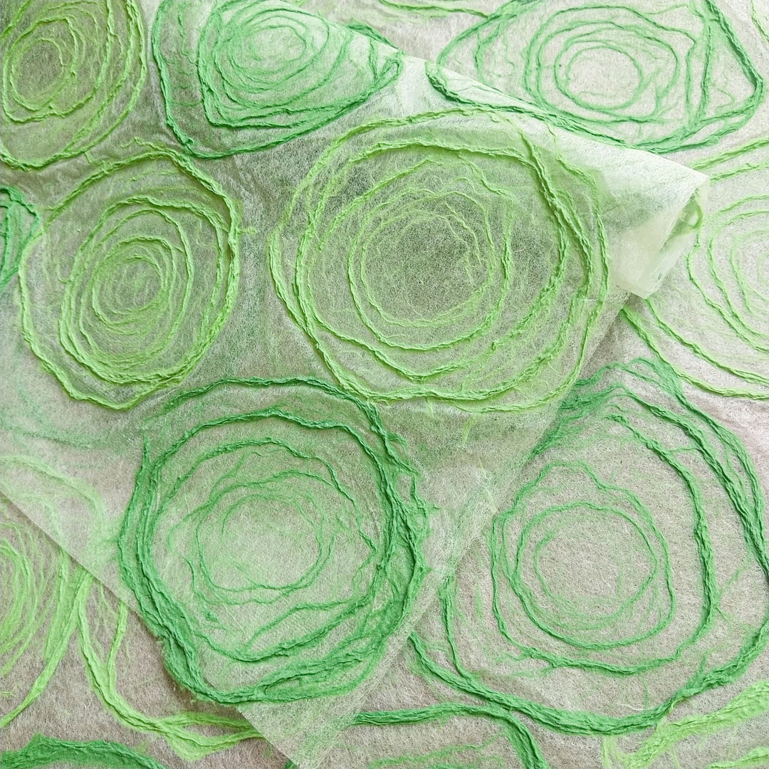 Artistic sheet of Kozo Studio's handmade mulberry paper with hand-drawn pulp circles in shades of green, suitable for crafting, lighting accents, and elegant projects.