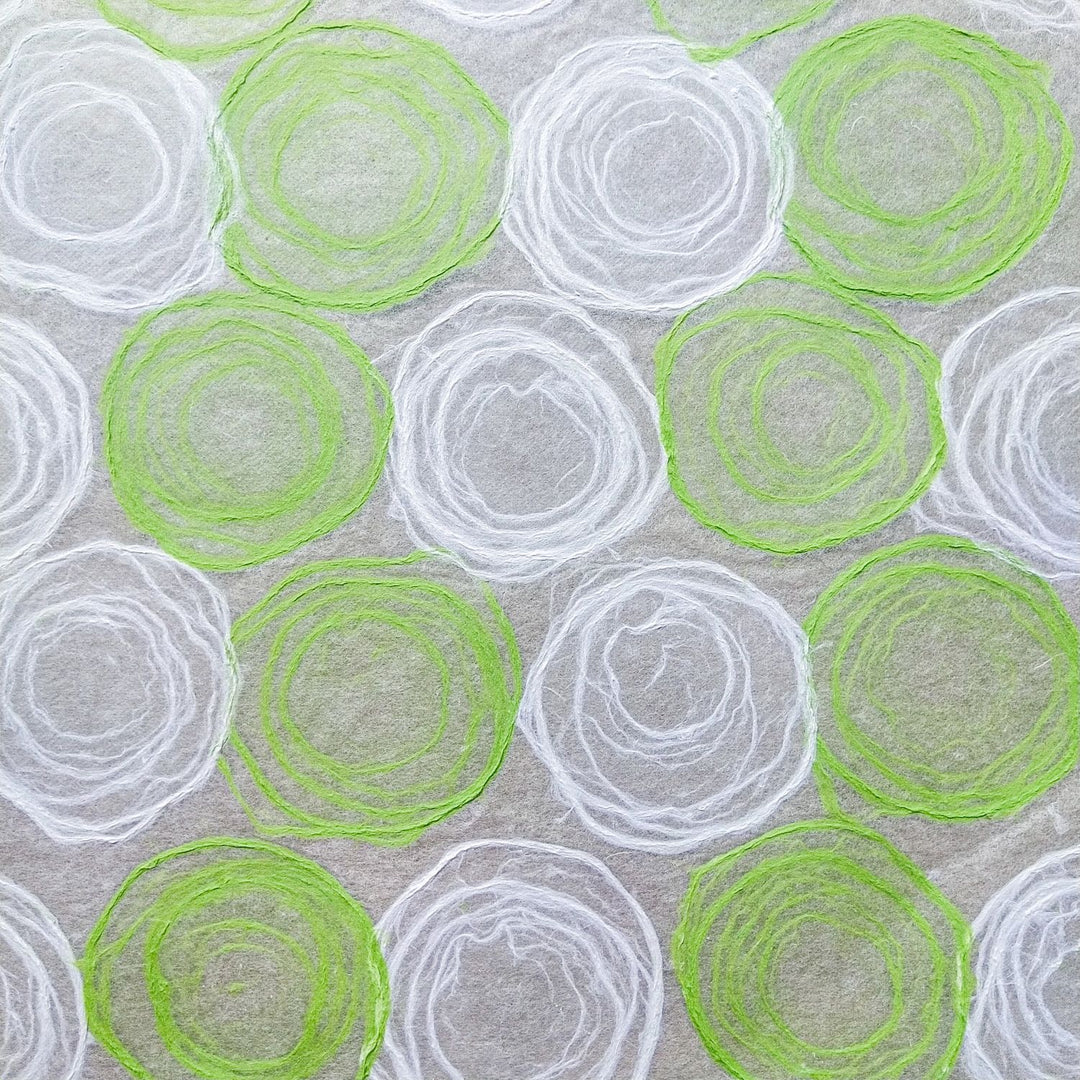 Translucent handmade paper from Kozo Studio, made of fine mulberry fibers with green and white pulp patterns, suited for craft and design work.