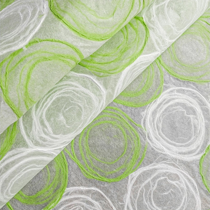 Decorative handmade paper by Kozo Studio, showcasing green and white designs on thin mulberry sheets, perfect for creative and interior projects.