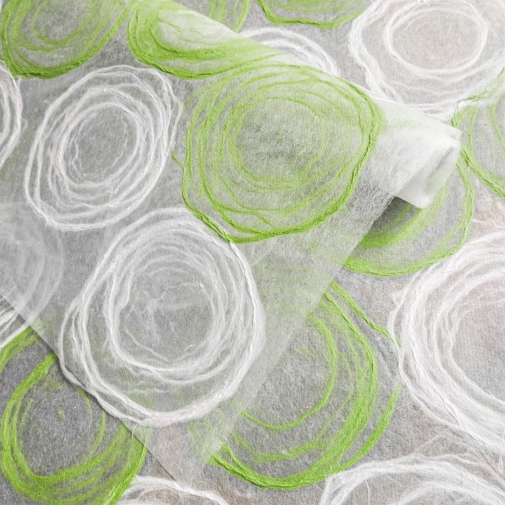 Kozo Studio's handmade mulberry paper with green and white circular motifs, offering a unique texture for artistic and decorative uses.