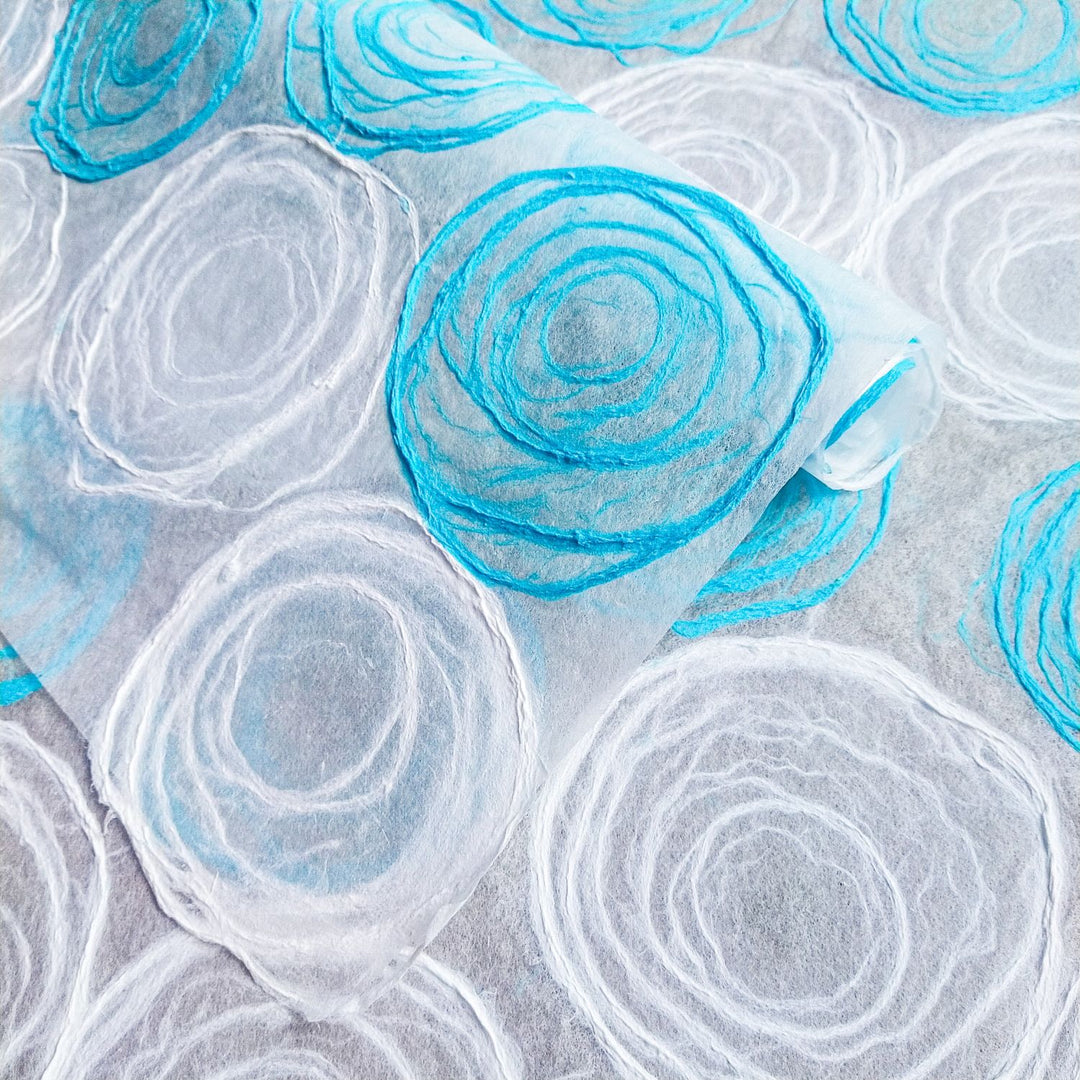 Elegant handmade kozo paper in soft light blue and white tones, crafted on thin translucent mulberry paper, perfect for creative uses from Kozo Studio.