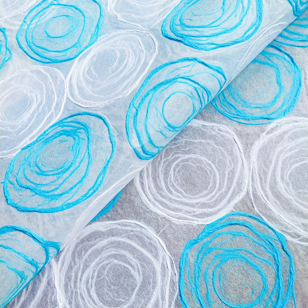 Light blue and white handmade rose kozo paper with delicate pulp circles on translucent mulberry paper from Kozo Studio, ideal for lamp and window shade projects.