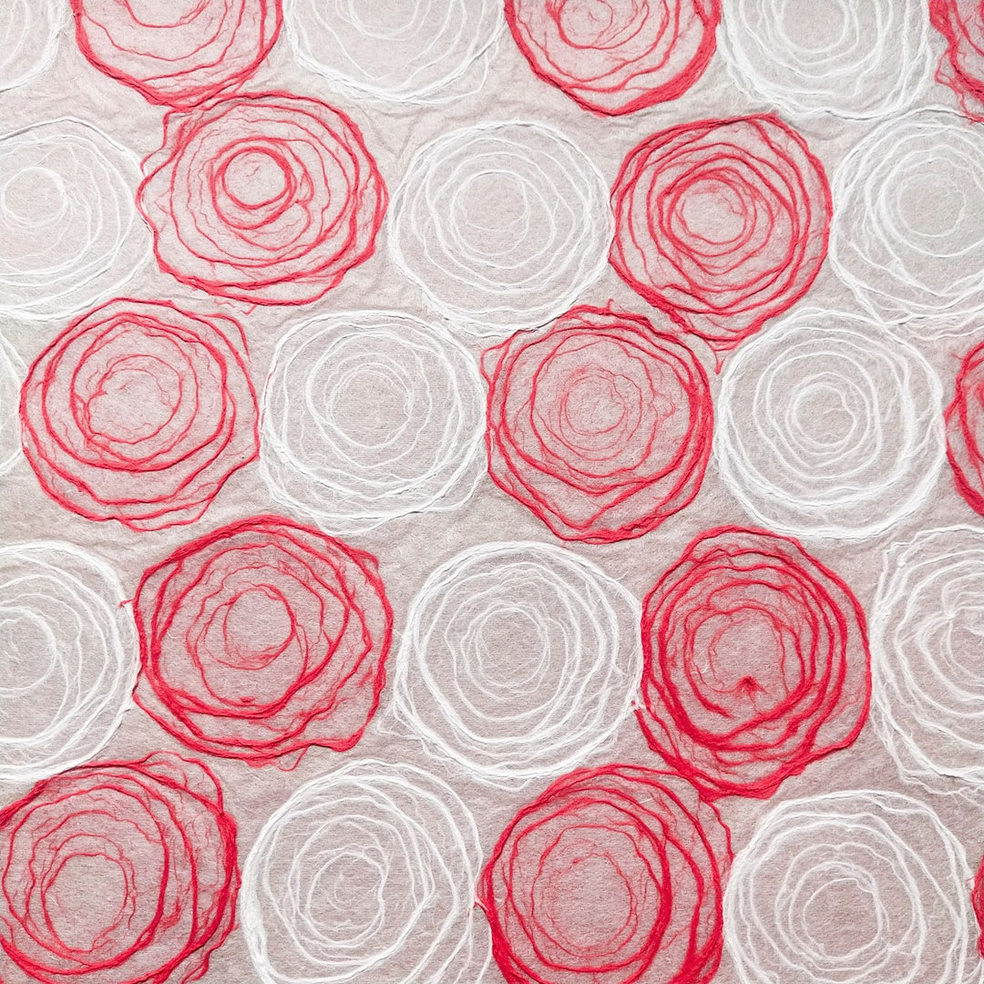 Artistic handmade mulberry paper by Kozo Studio showcasing hand-drawn pulp circles in red and white, suitable for creative designs.