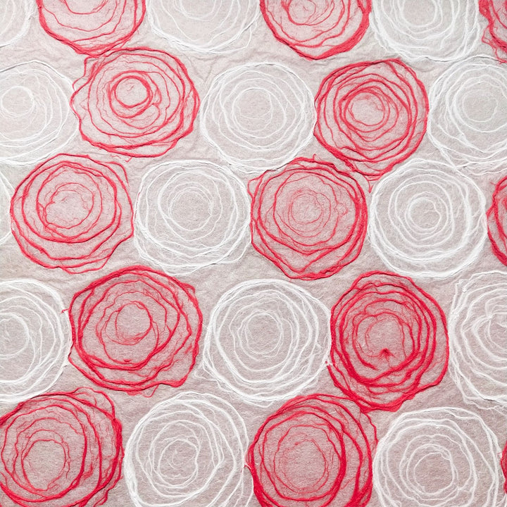 Artistic handmade mulberry paper by Kozo Studio showcasing hand-drawn pulp circles in red and white, suitable for creative designs.