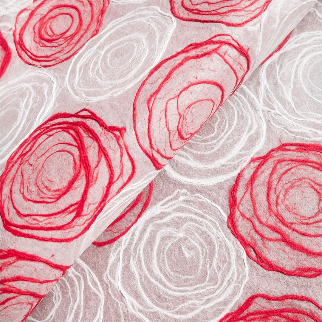 Red and white handmade mulberry paper from Kozo Studio with circular pulp patterns, perfect for lampshades and craft projects.