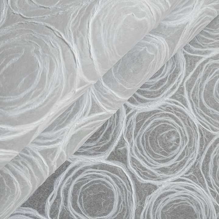Translucent handmade paper with rose pulp designs by Kozo Studio, made from fine mulberry paper for versatile artistic use.