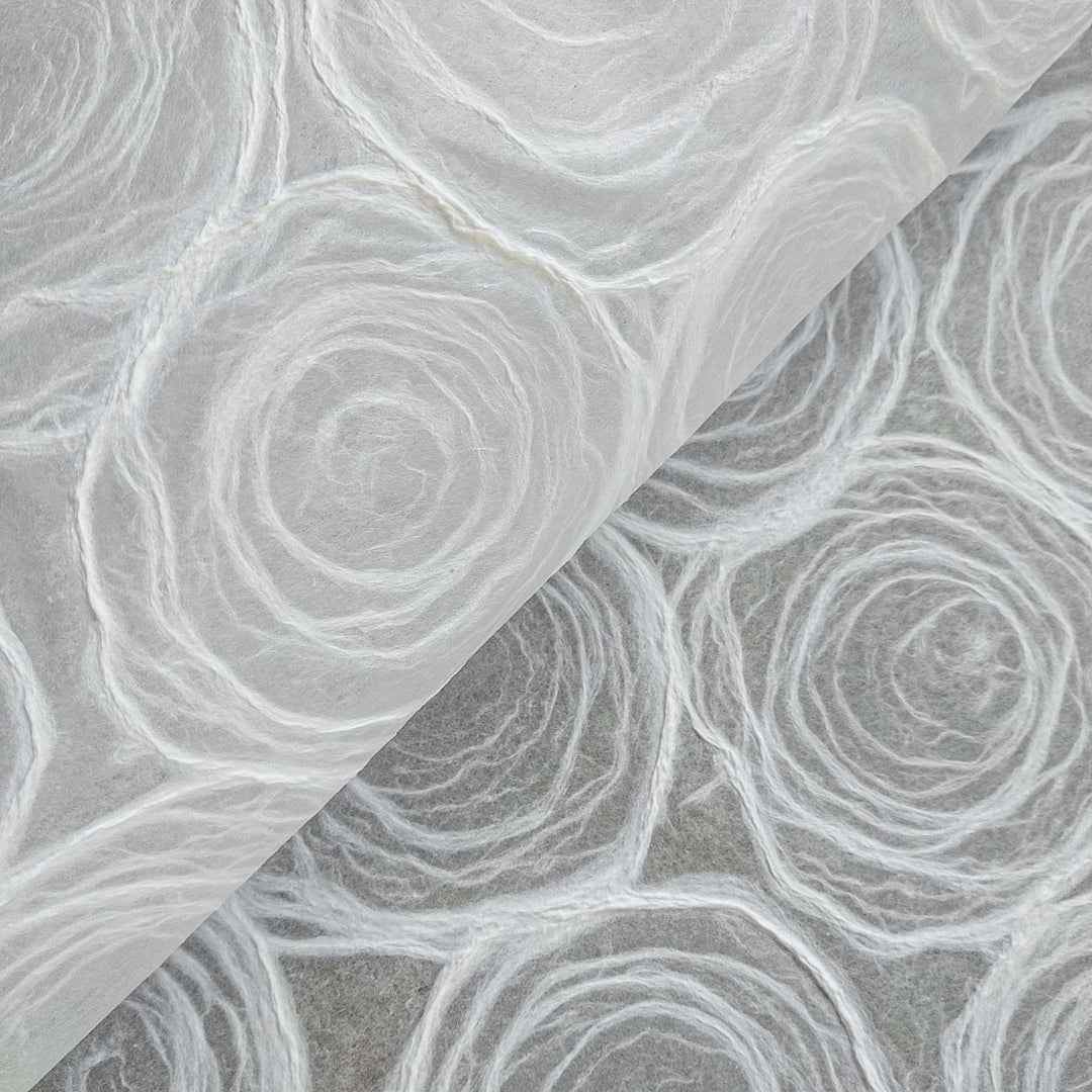 Handmade rose kozo paper in white with translucent mulberry base, crafted by Kozo Studio for lampshades and artistic projects.