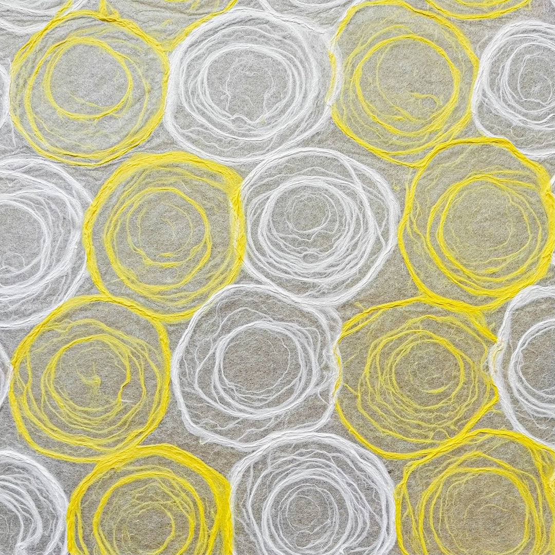 Artistic sheet of handmade paper from Kozo Studio showing soft yellow and white rose patterns drawn on translucent mulberry paper, perfect for crafting.