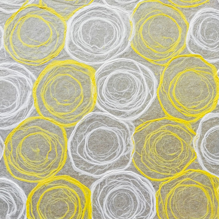 Artistic sheet of handmade paper from Kozo Studio showing soft yellow and white rose patterns drawn on translucent mulberry paper, perfect for crafting.