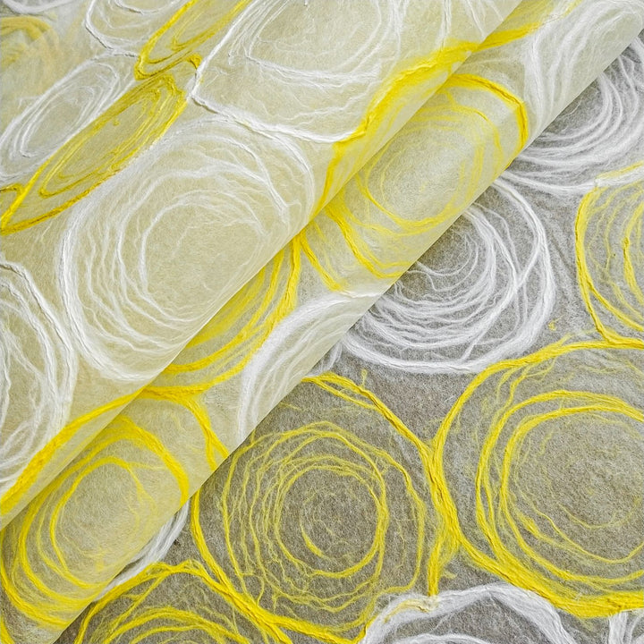 Kozo Studio handmade paper with circular yellow and white rose motifs on sheer mulberry paper, blending elegance and versatility for craft enthusiasts.