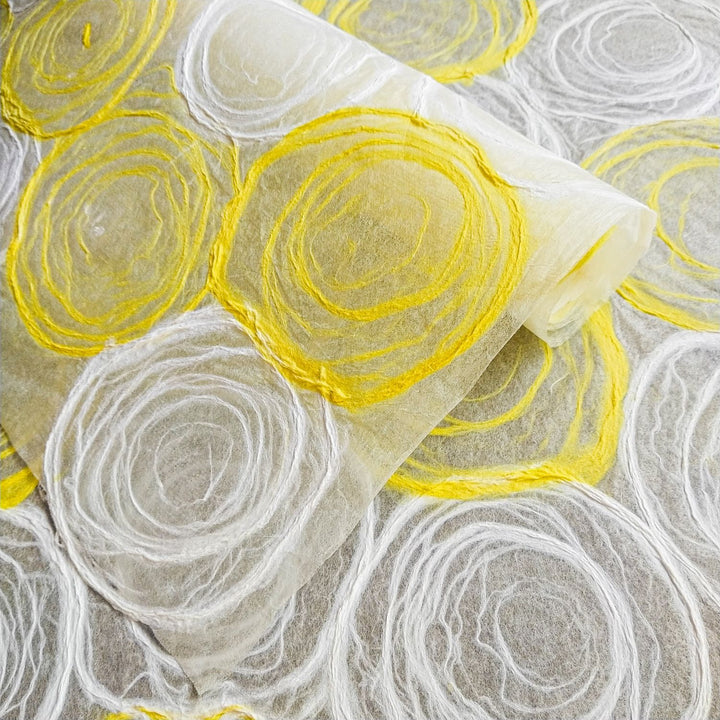 Elegant translucent mulberry paper from Kozo Studio featuring handmade yellow and white rose patterns, ideal for lamps, windows, and fine art projects.